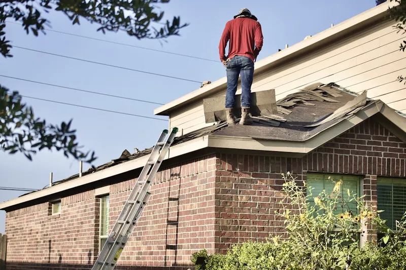 Professional roofer working on a residential roof in Palm